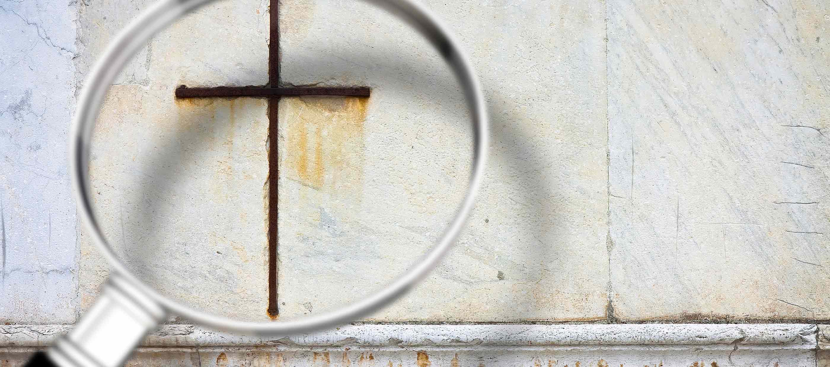magnifying glass over an image of a cross