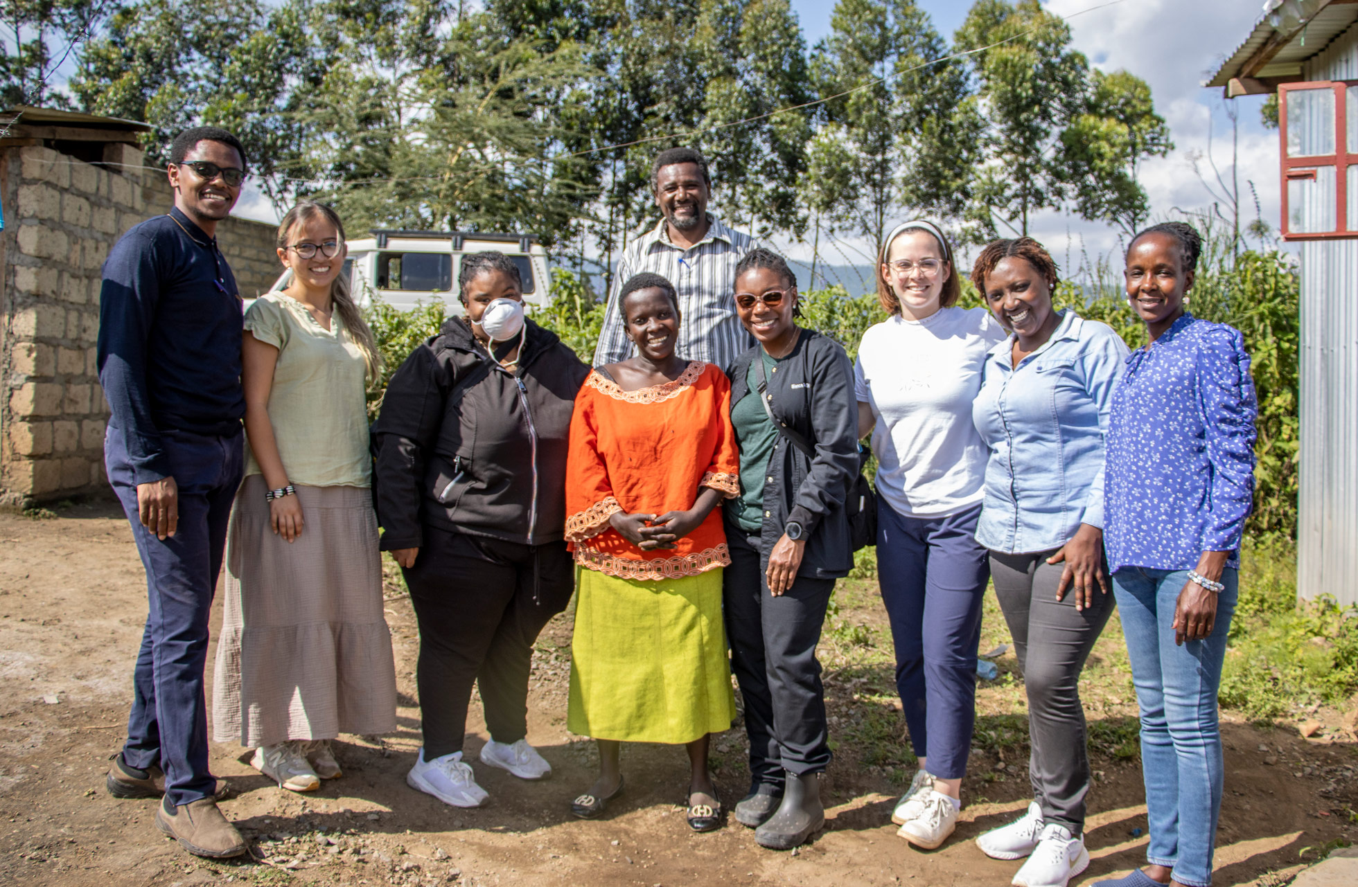 Social work students and team leader pose with group in Kenya
