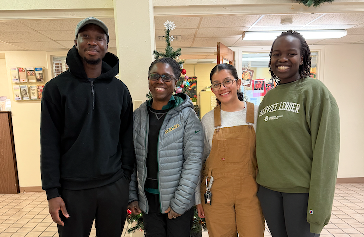 Students pose with Dr. Stephanie Boddie at their eco social work internship site Da'Shack