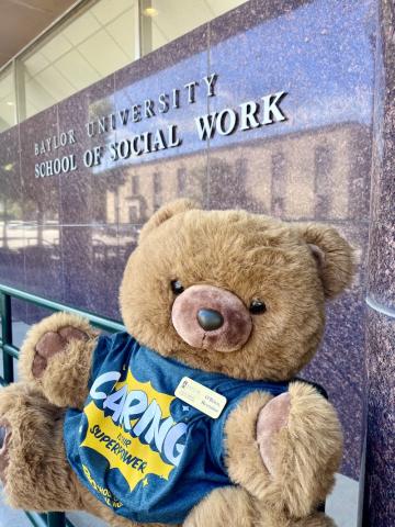 O'Brien the bear sits in front of the Baylor social work building