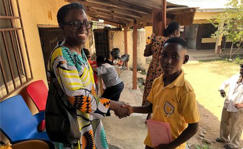 Dr. Boddie shaking hands with a young student in Ghana