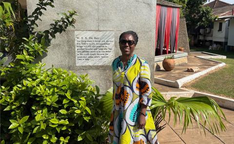 Dr. Boddies posing in front of a plaque honoring W.E. Dubois in Ghana