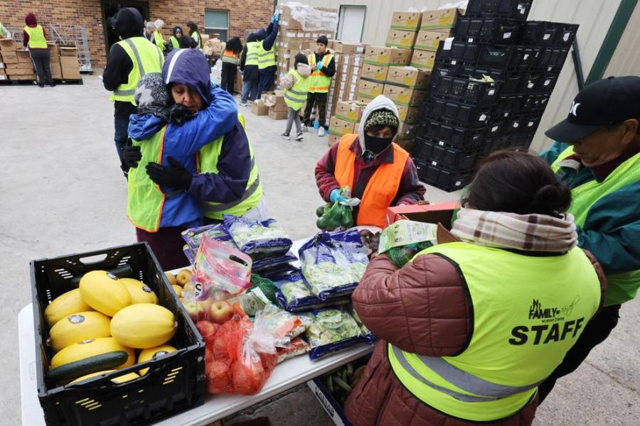 volunteers hand out fresh food to those in need