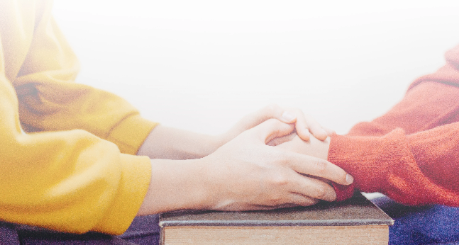 Caring hands over a book