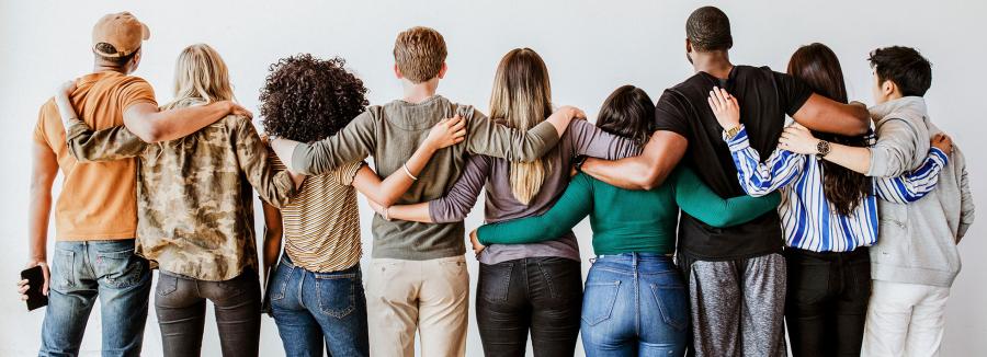 diverse group of people arms locked together