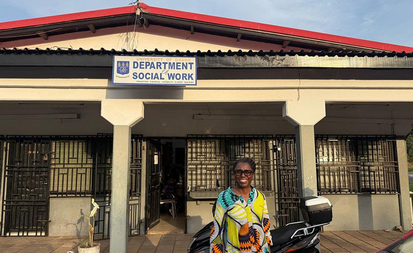 Dr. Stephanie Boddie standing outside the Department of Social Work building at the University of Ghana
