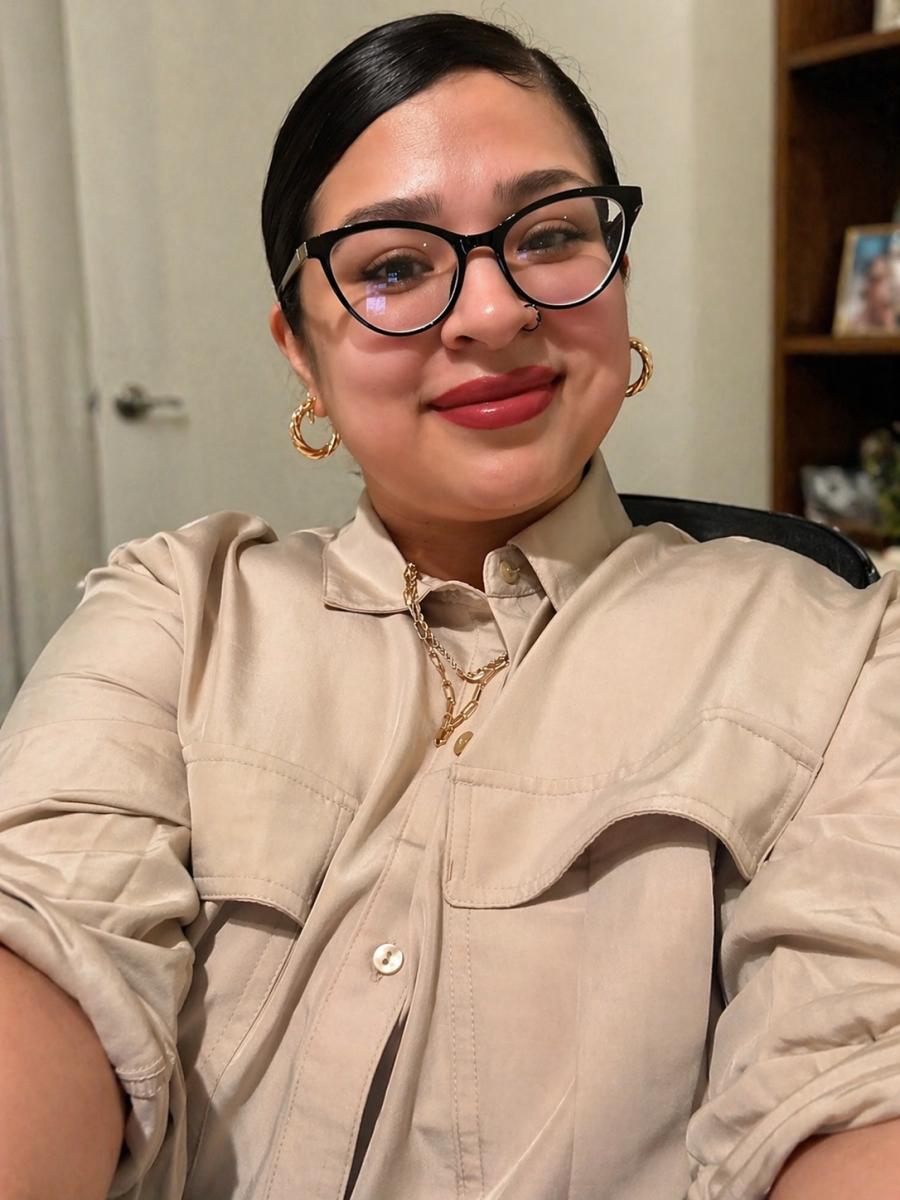Antonianett Garcia smiling for the camera in a khaki shirt
