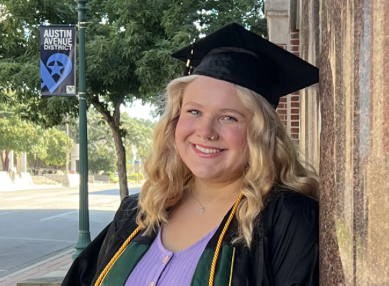 Miah Carter in graduation attire outside Garland School building