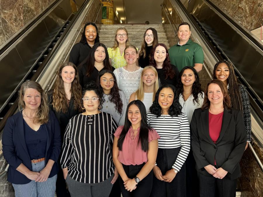 Becky Scott and Lindsey Robidas on the stairs of the GSSW with 15 students from the 2026-2027 IBH cohort