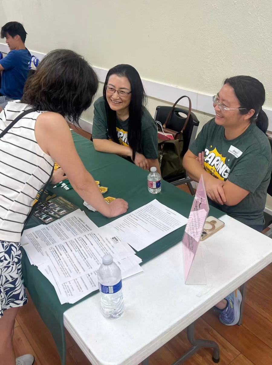 Dr Ling Xu and Dr Jinyu Liu talking with an attendance of the Dallas Chinese Community Center