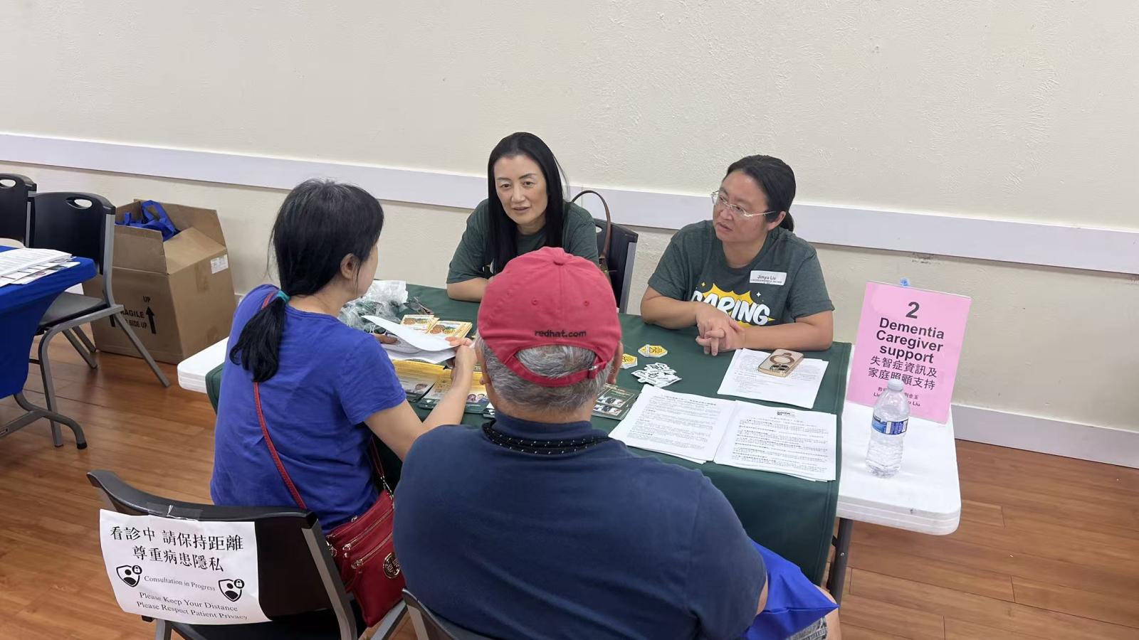 Dr Ling Xu and Dr Jinyu Lu talking with attendants of the Dallas Chinese Community Center Health Fair